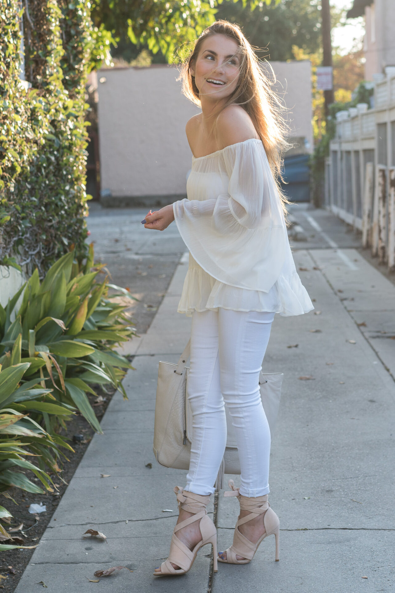 white off the shoulder top with ruffle trim white skinny jeans angela lanter hello gorgeous
