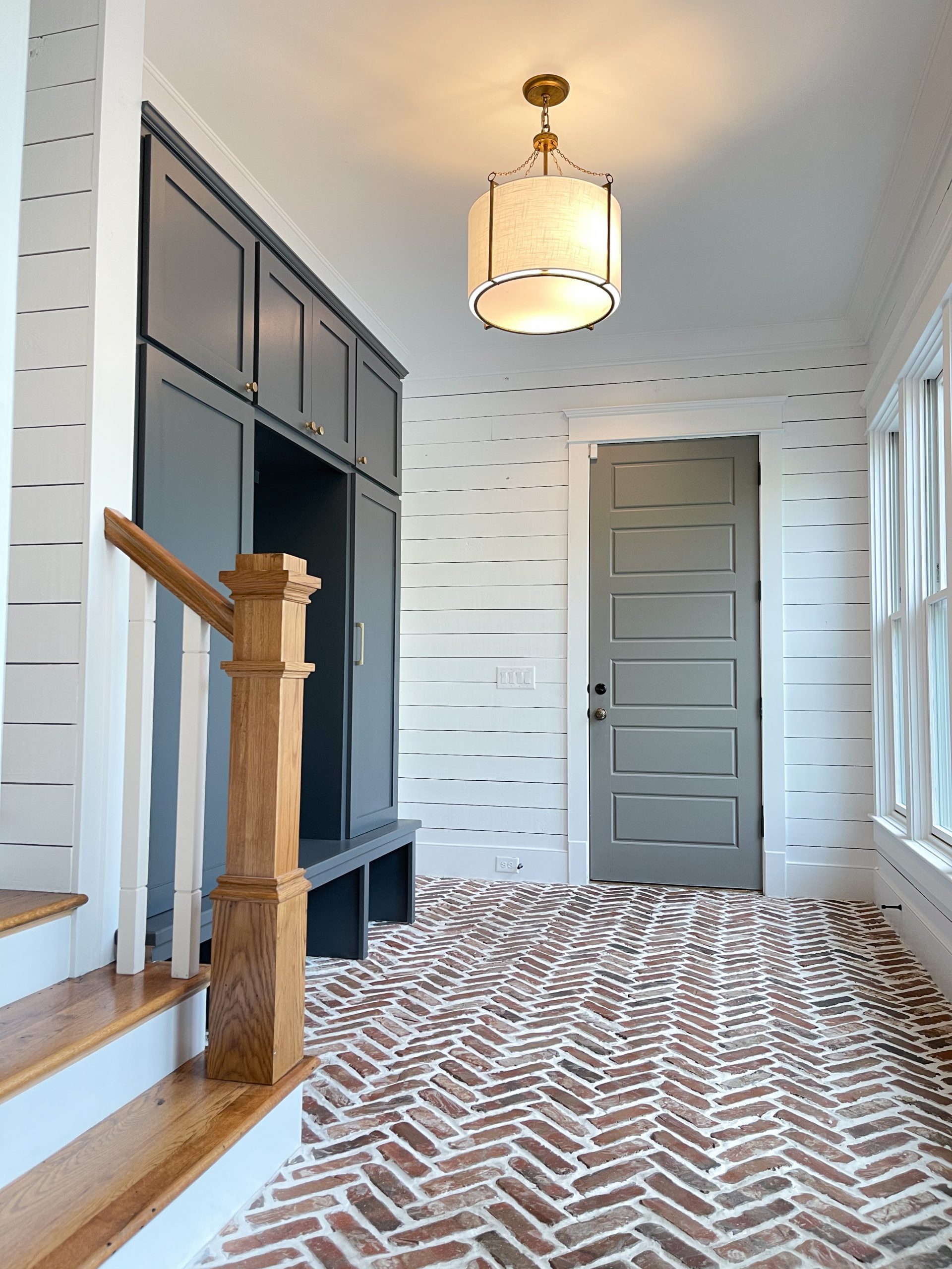 nashville, tn herringbone brick floors navy built-in cabinets white shiplap