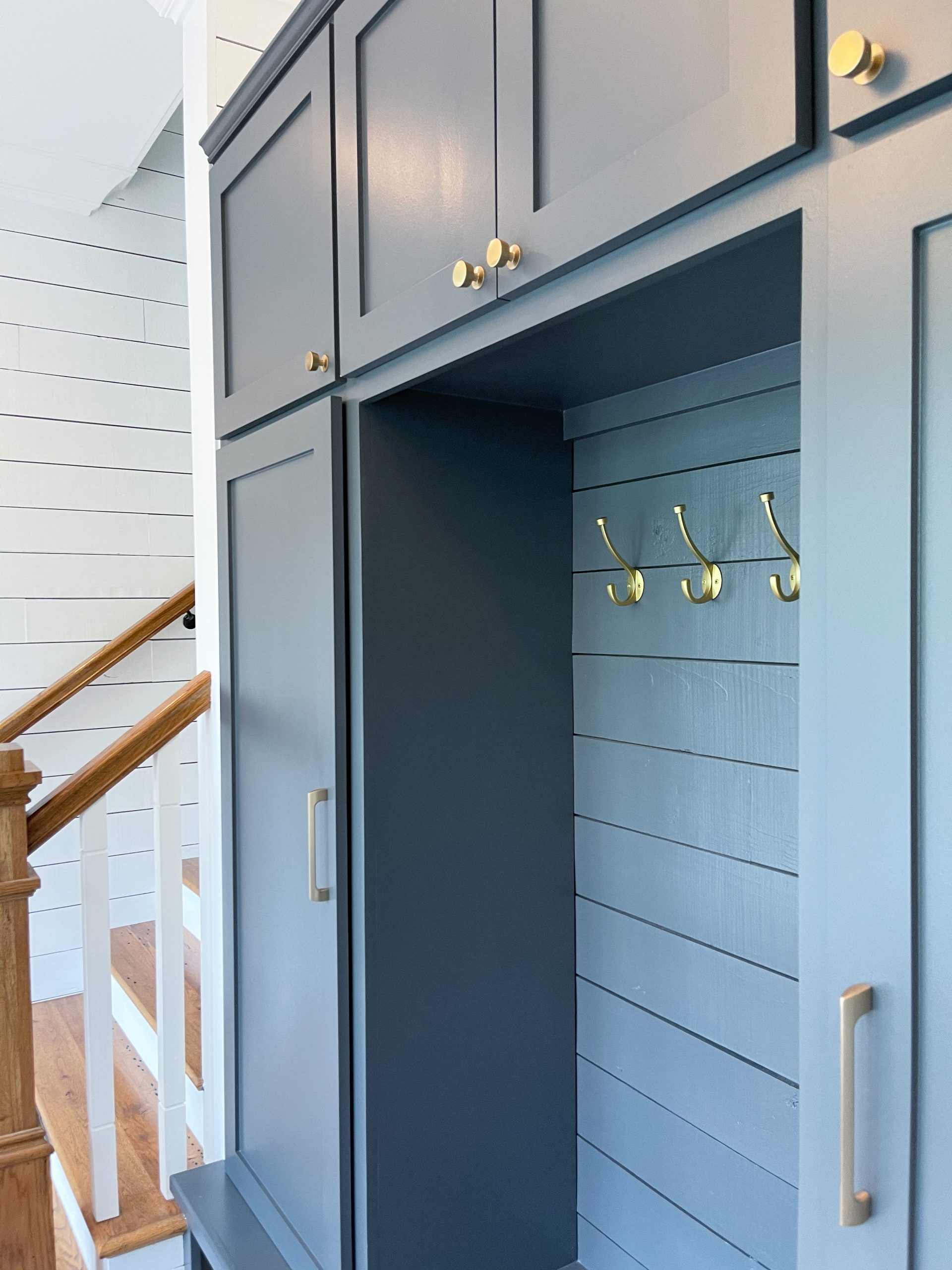 coastal mudroom makeover nashville, tn herringbone brick floors navy built-in cabinets white shiplap