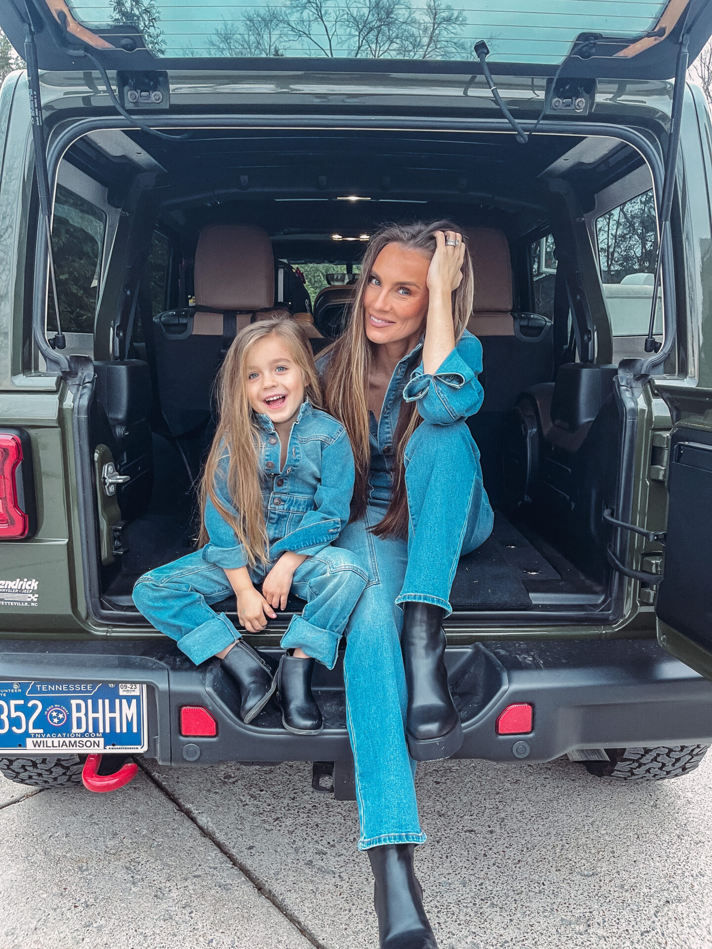 green linen jumpsuit blog post by fashion blogger Angela Lanter and daughter MacKenlee Lanter wearing matching denim jumpsuits from Walmart in back of hunter green Jeep Wrangler