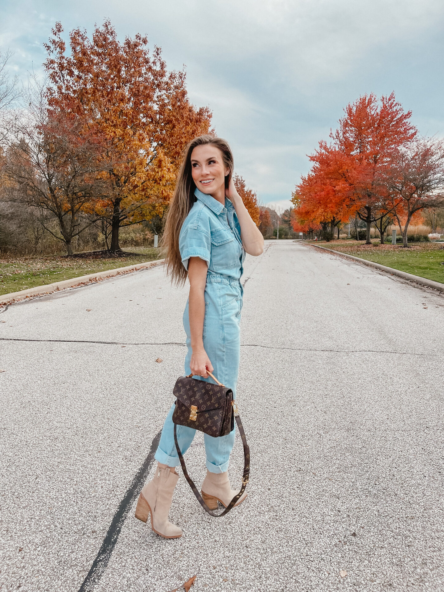green linen jumpsuit blog post by fashion blogger Angela Lanter wearing Free People We the Free Marci Denim Jumpsuit with Nordstrom tan suede booties and Louis Vuitton Pochette Metis in Hudson, Ohio