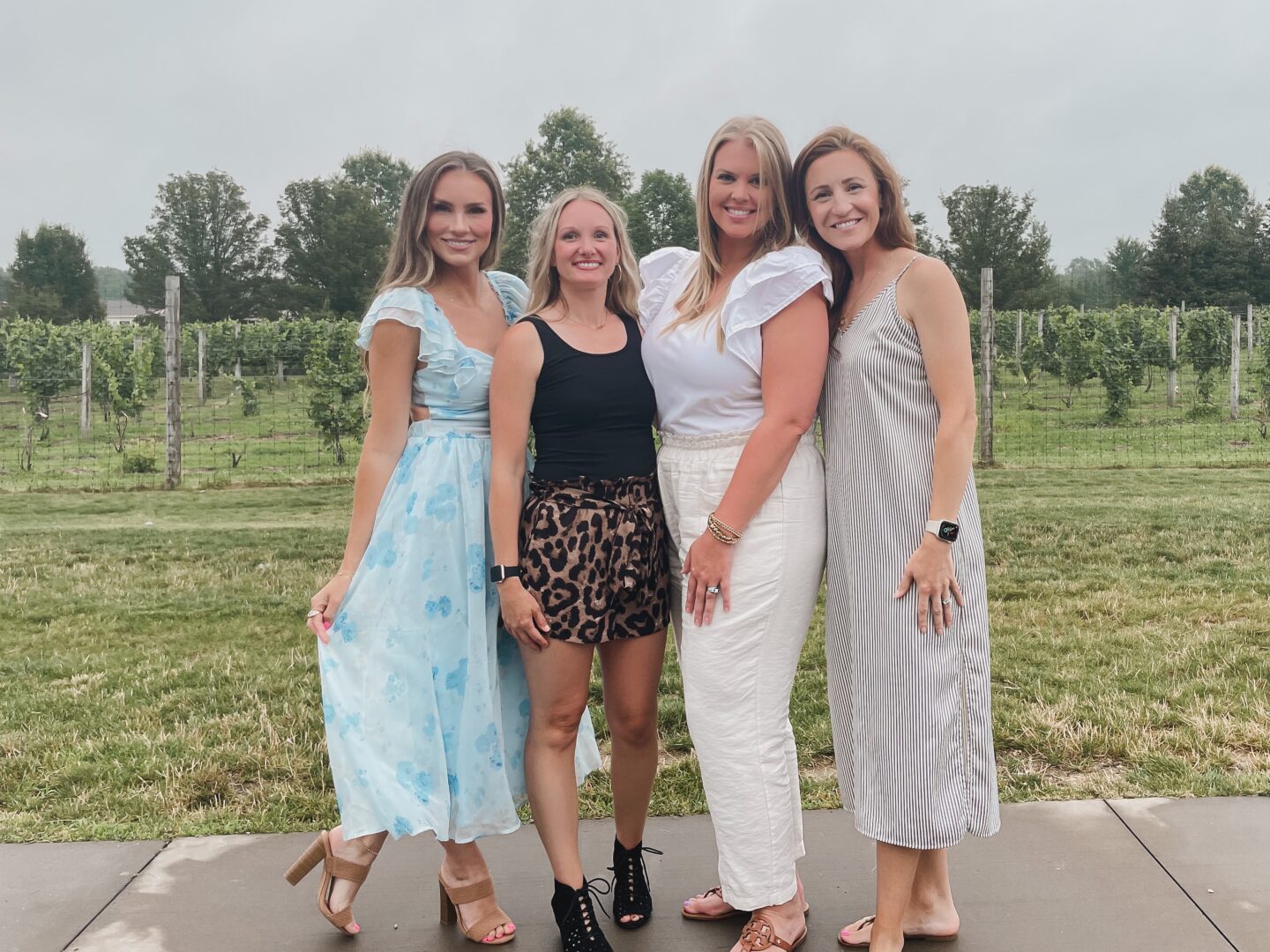 Fashion blogger Angela Lanter wearing floral ruffle dress from Lulu's with friends at Michael Angelo's Winery in Richfield, Ohio