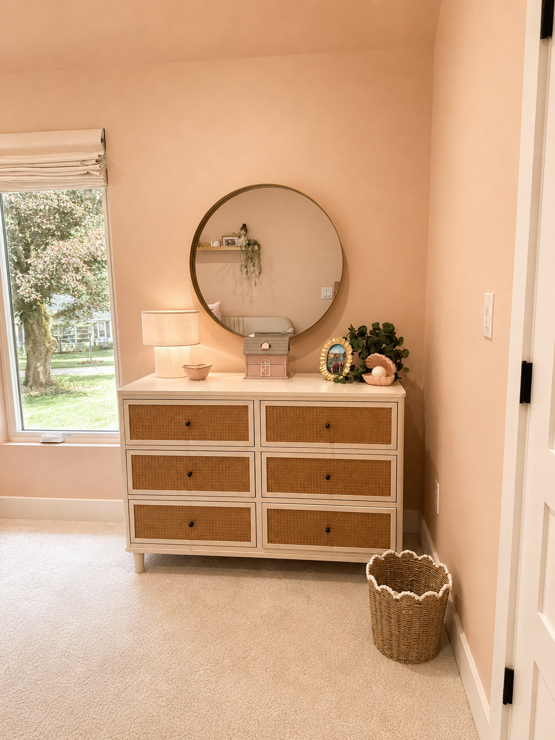 girl bedroom dresser vignette with round mirror and warm lamp